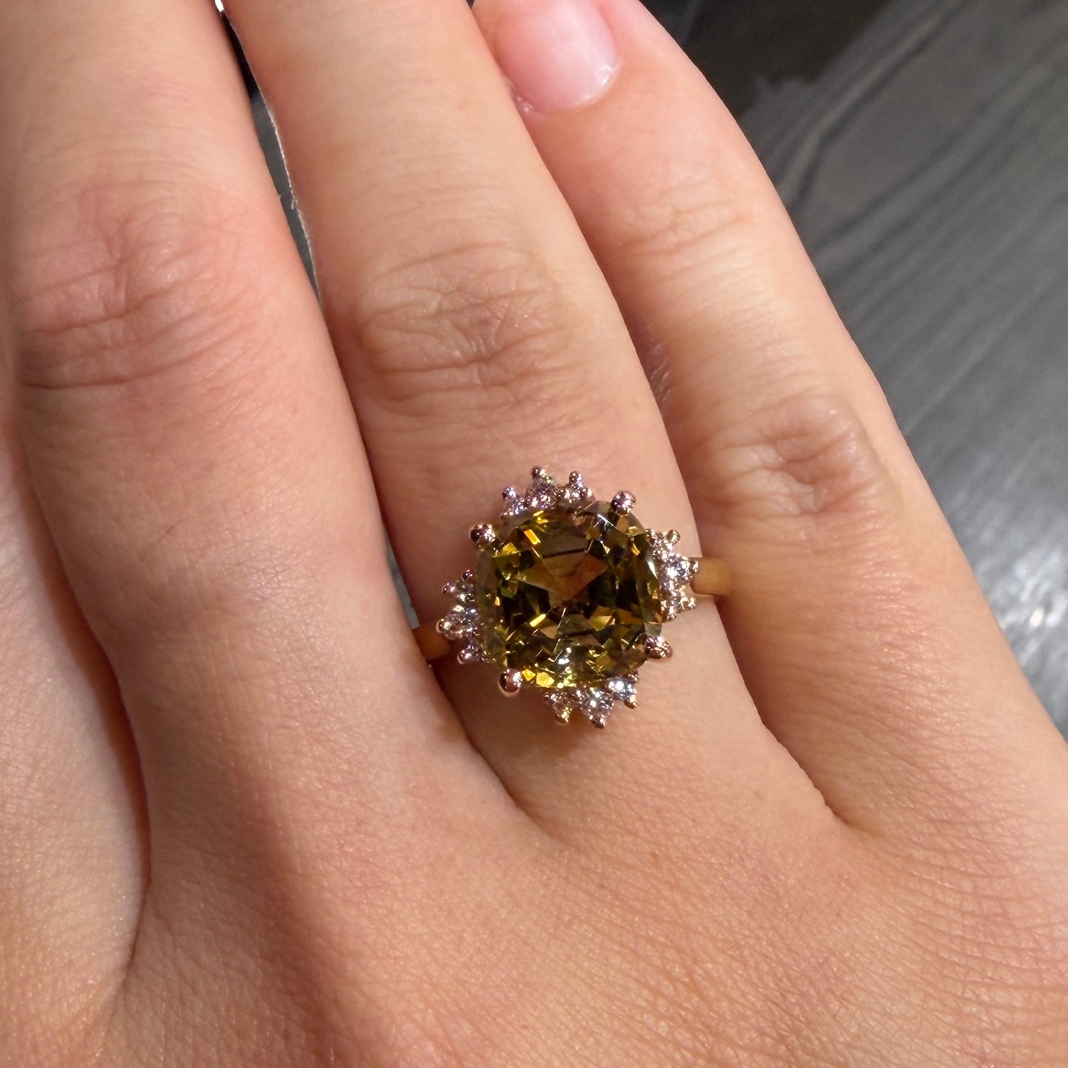 18ct rose and yellow gold dress ring with cushion cut tourmaline in an autumn bi-colour tone. Surrounded by diamonds