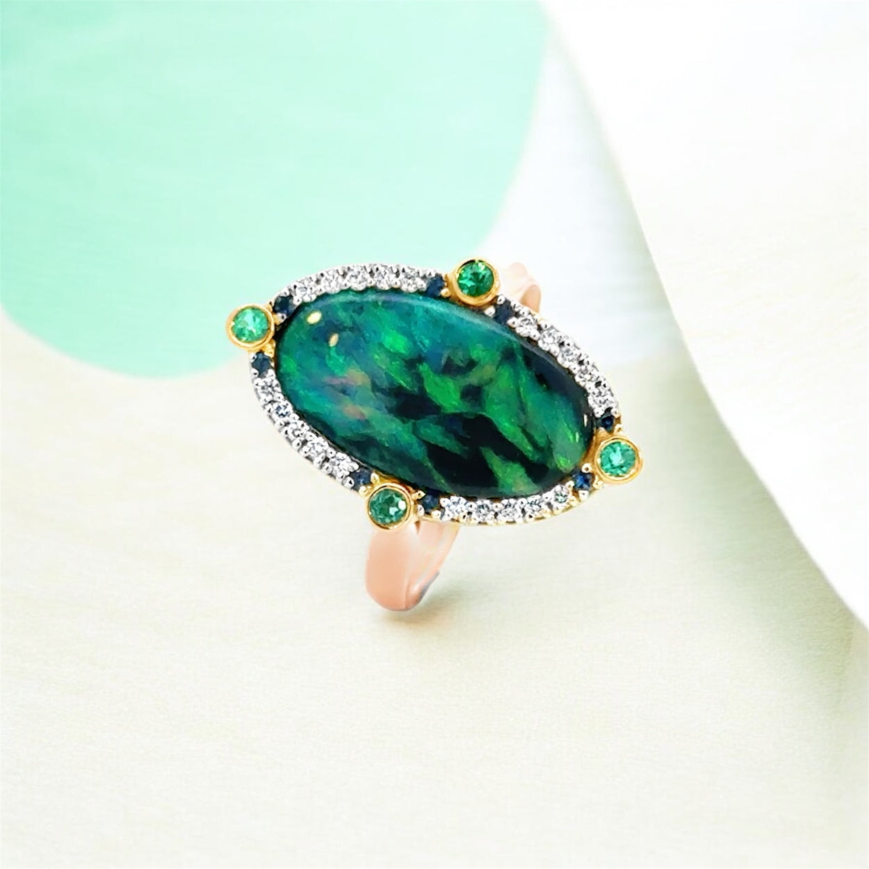 Handcrafted Australian solid black opal ring with diamonds, Australian sapphires and Paraíba tourmaline, vivid blue green colour play, Melbourne jewellery designer Trewarne.
