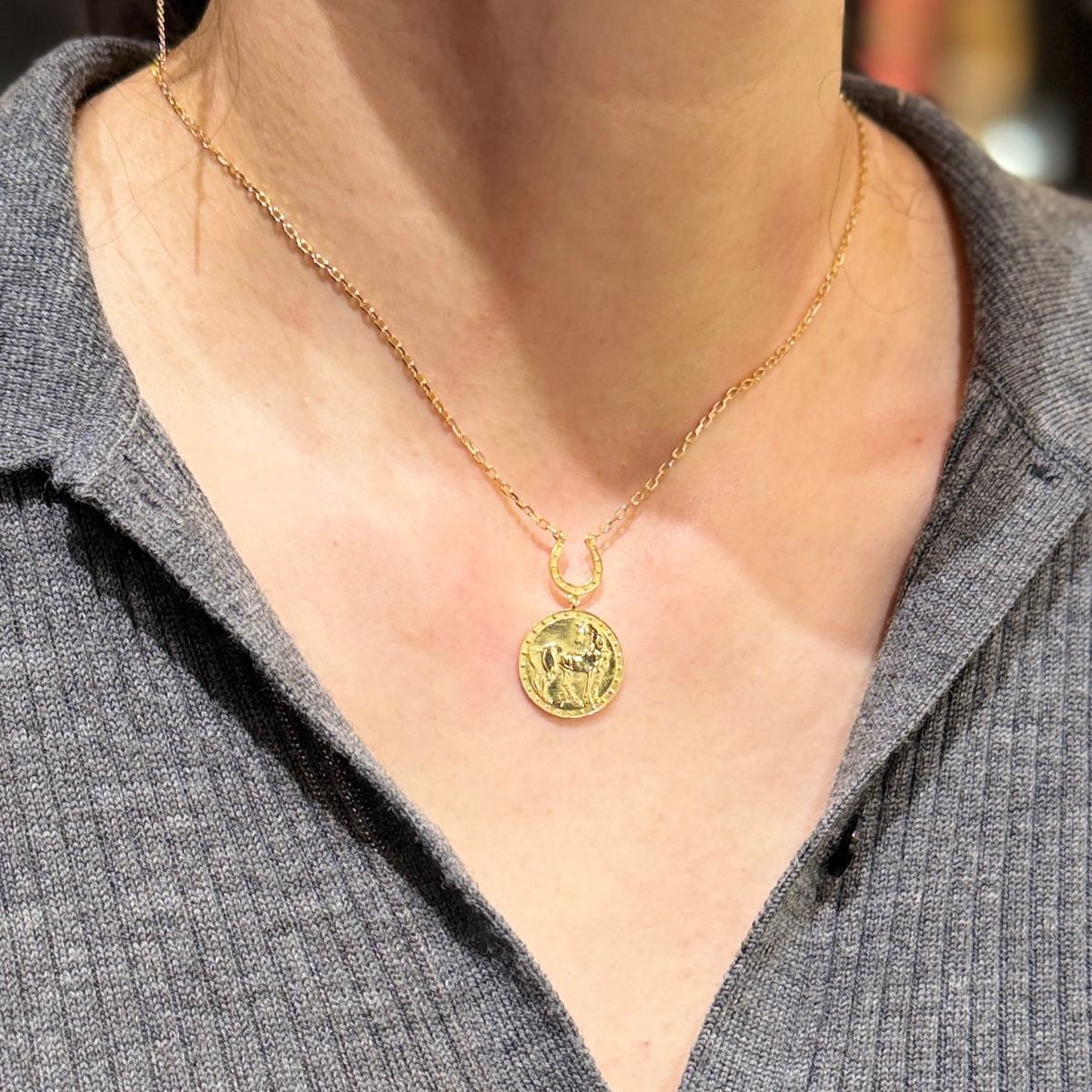 Lady wearing Hose medallion necklace