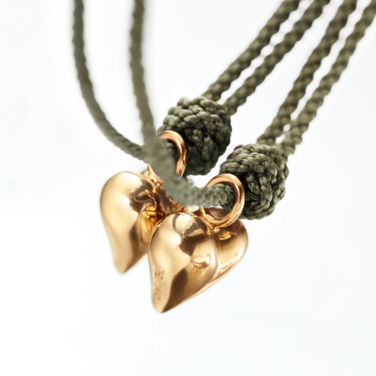 Ole Lynggaard connected heart bracelets a pair on green string