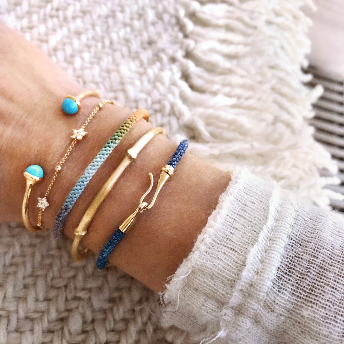 Lady wearing Ole Lynggaard Nature and Life and shooting star bracelets