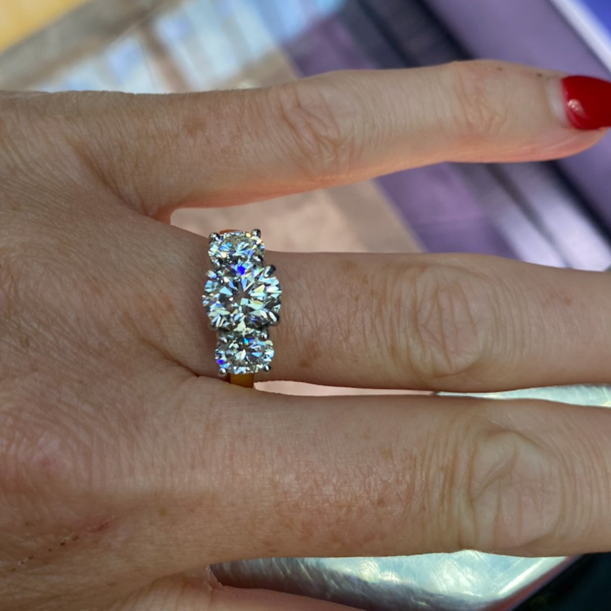 Close up of Ideal Oval Trilogy diamond ring