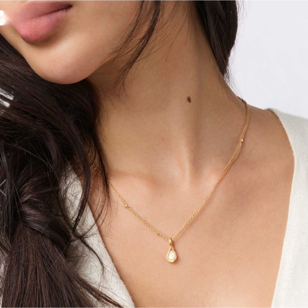 Model wearing ole lynggaard pcean drop solitaire pendant