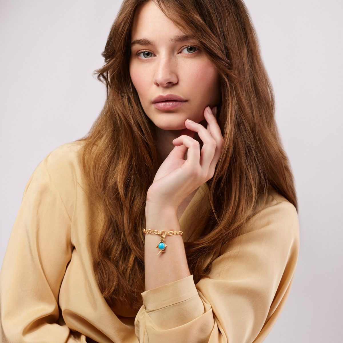 Woman wearing Young Fish charm with Turquoise charm on Love Bracelet
