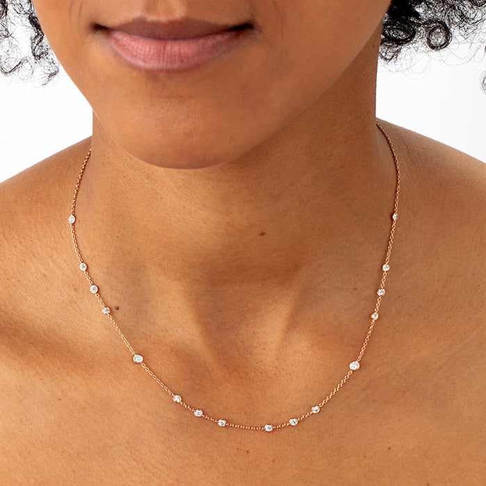 Rose gold bezel set diamond necklace on model