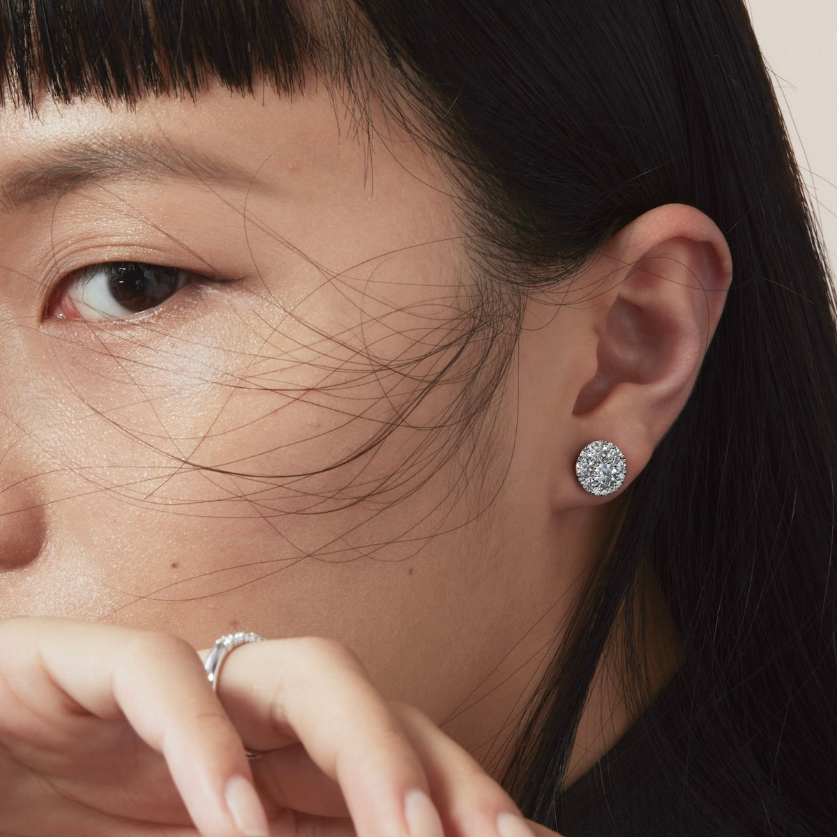 close up of a woman wearing hearts on fire diamond stud earrings in the Tessa mosaic style 18ct white gold