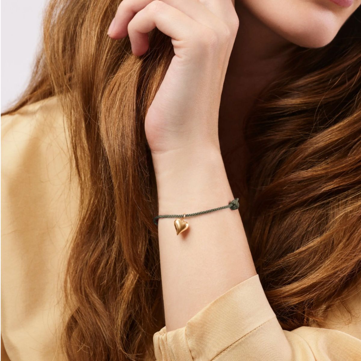 Lady wearing ole lynggaard connected heart bracelet