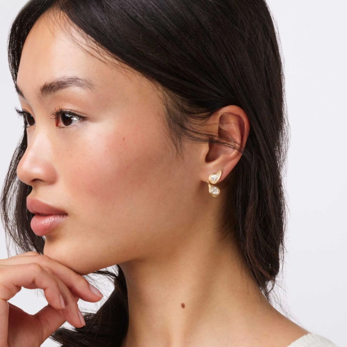 model wearing ole lynggaard ocean drop solitaire studs with ocean drop pendants