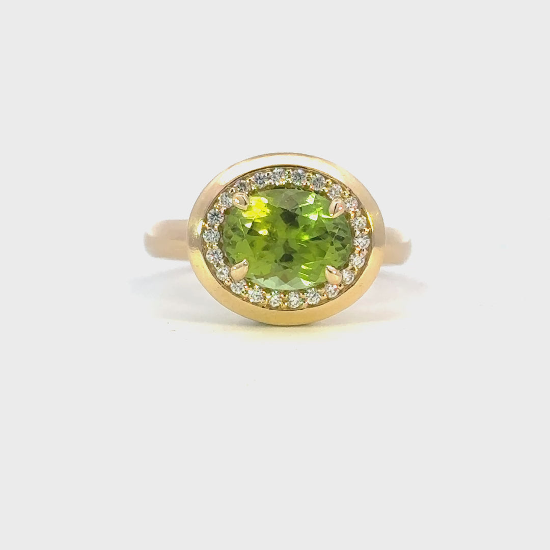 Peridot and diamond halo style ring in 18ct yellow gold